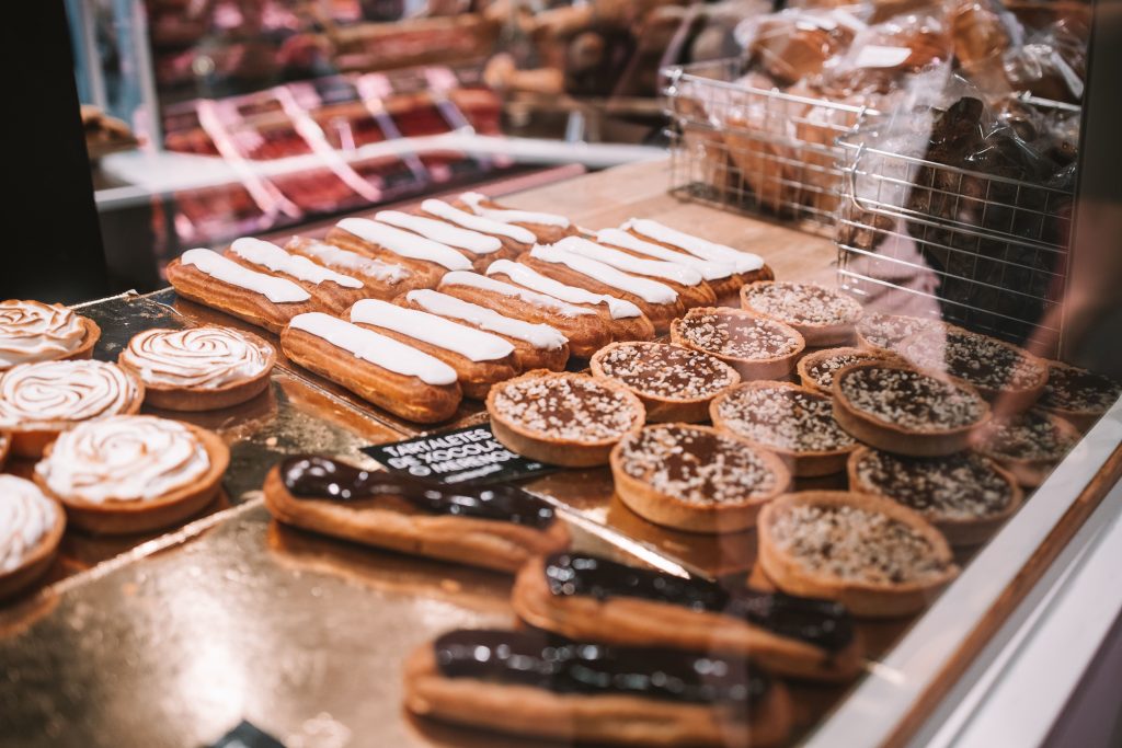 a display case filled with lots of different types of cakes and pies on display in a bakery or deli or bakery shop