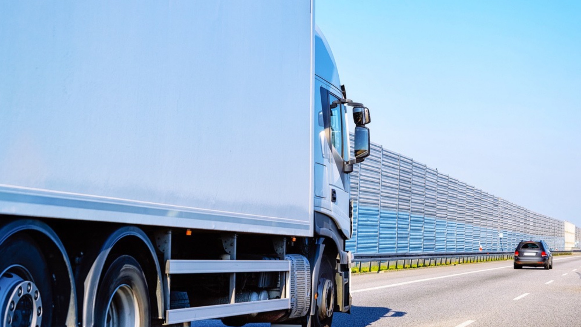 White lorry travelling along a motorway on a sunny day